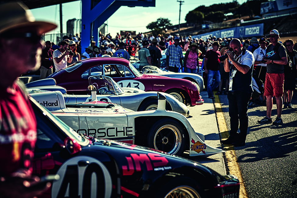 Porsche Rennsport Reunion featuring vintage race cars and a crowd of Porsche fans