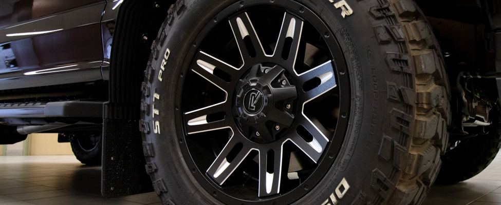 Aftermarket off-road wheels, mud flaps and mud-terrain tires on a Ford F-150