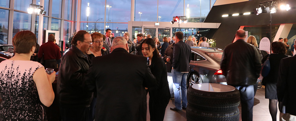 Guests enjoying refreshments and appetizers on the Audi sales floor.