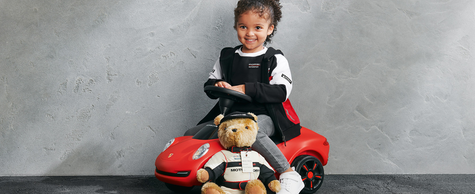 Child with Porsche Motorsport teddy bear