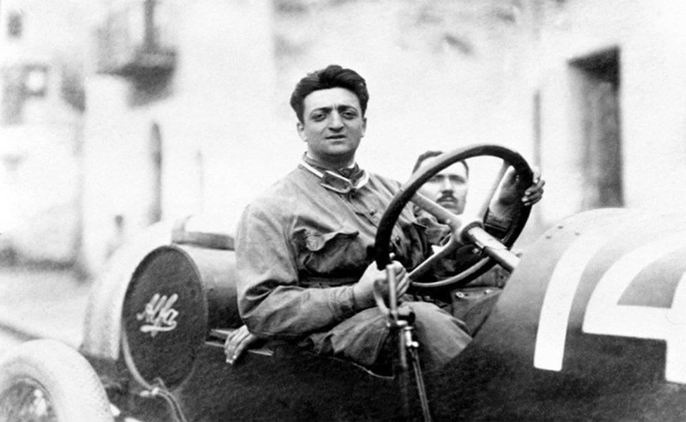 Enzo Ferrari driving an Alfa Romeo.